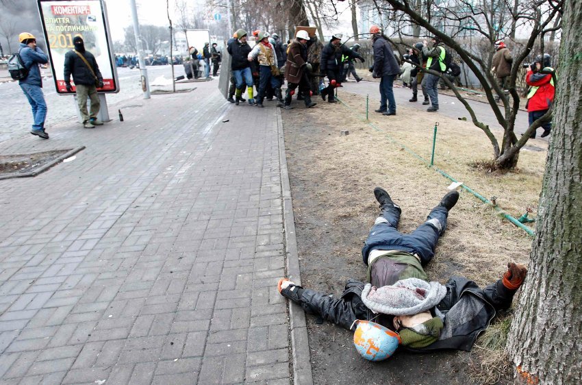 A dead body is seen on the ground after violence erupted in the Independence Square in Kiev